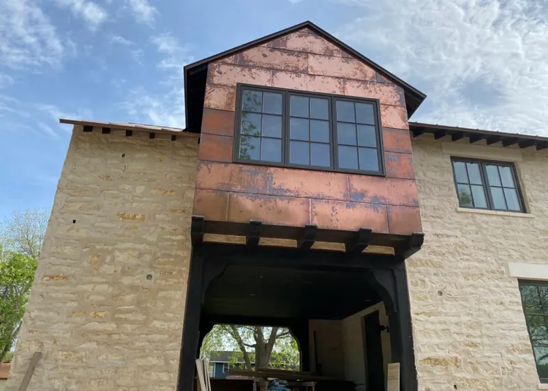 Copper metal panel facade on a stone building for Roof Repair in El Reno